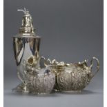 A late Victorian repousse silver sugar bowl and cream jug and a sterling white metal sugar caster.