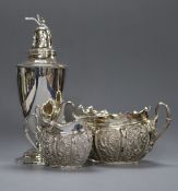 A late Victorian repousse silver sugar bowl and cream jug and a sterling white metal sugar caster.