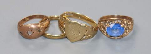 Three 9ct gold rings including a signet ring and a yellow metal ring.