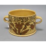 A 17th century style slipware posset pot by John Hudson, impressed 'H' to base, with twin lug