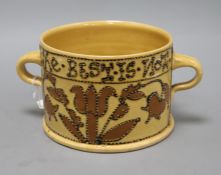 A 17th century style slipware posset pot by John Hudson, impressed 'H' to base, with twin lug