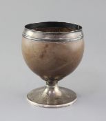 A George III silver mounted pedestal coconut cup, by Phipps & Robinson, with reeded foot, London,