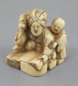 An ivory netsuke of a woman and child, 19th century, kneeling before a large stone, beating cloth,