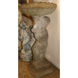 A reconstituted stone bird bath with putti support W.38cm