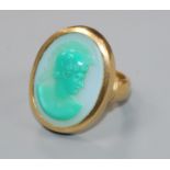 A 1950's 22ct gold and sardonyx set oval ring, carved with head of a Roman soldier to sinister, size