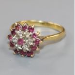 An 18ct gold, ruby and diamond flower head cluster ring, size P.