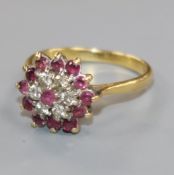 An 18ct gold, ruby and diamond flower head cluster ring, size P.