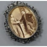 A white metal mounted oval photograph frame, 9.8cm.
