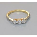 An 18ct gold and three stone diamond ring, size J.