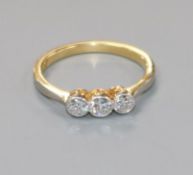 An 18ct gold and three stone diamond ring, size J.