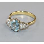 A modern 18ct gold, aquamarine and diamond set dress ring, size N.