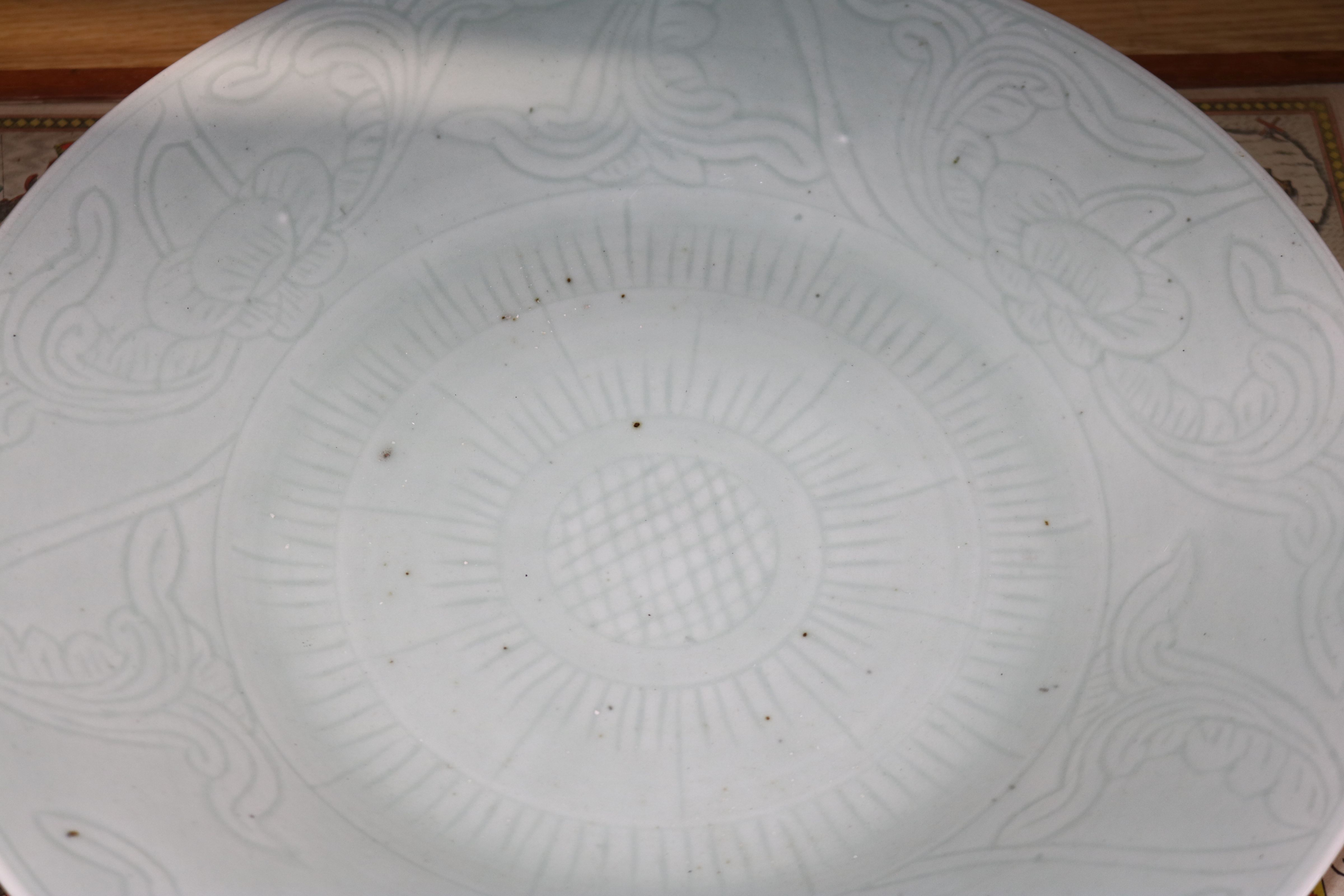 A Chinese celadon glazed dish, 19th century, the centre incised with a flowerhead, 5the borders with - Image 3 of 5