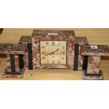 An Art Deco rouge marble clock garniture