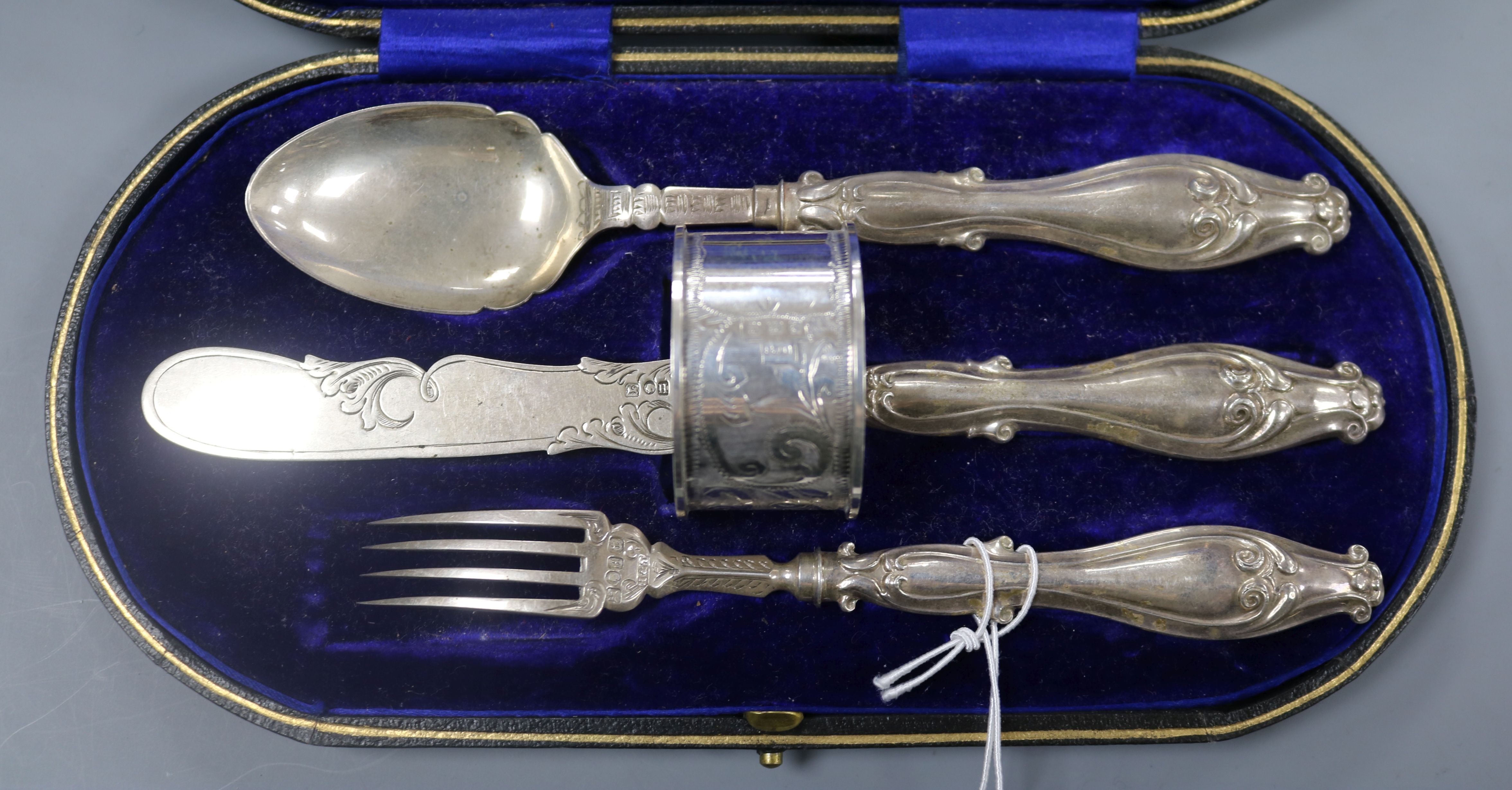 A Victorian cased silver christening trio, together with a later silver napkin ring.