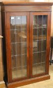 A bookcase with double glazed doors and three shelves W.92cm