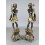 A pair of Italian parcel silvered painted wood blackamoors, each standing holding a cornucopia, H.