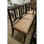 A George III mahogany elbow chair and two matching single chairs