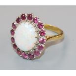 An 18ct gold, white opal and ruby set oval cluster dress ring, size L.