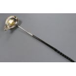 An 18th century white metal toddy ladle, the bowl inset with Queen Anne silver half crown, 38cm.