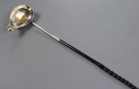 An 18th century white metal toddy ladle, the bowl inset with Queen Anne silver half crown, 38cm.