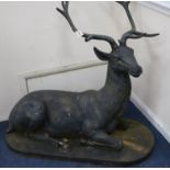A large bronzed metal model of a recumbent stag H.88cm