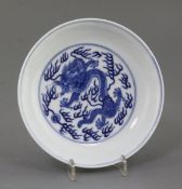 A Chinese blue and white 'dragon' dish, the interior with a single dragon chasing a flaming pearl,