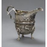 A George V embossed silver cream jug, Charles Lambe, Dublin, 1921, 8.4cm.