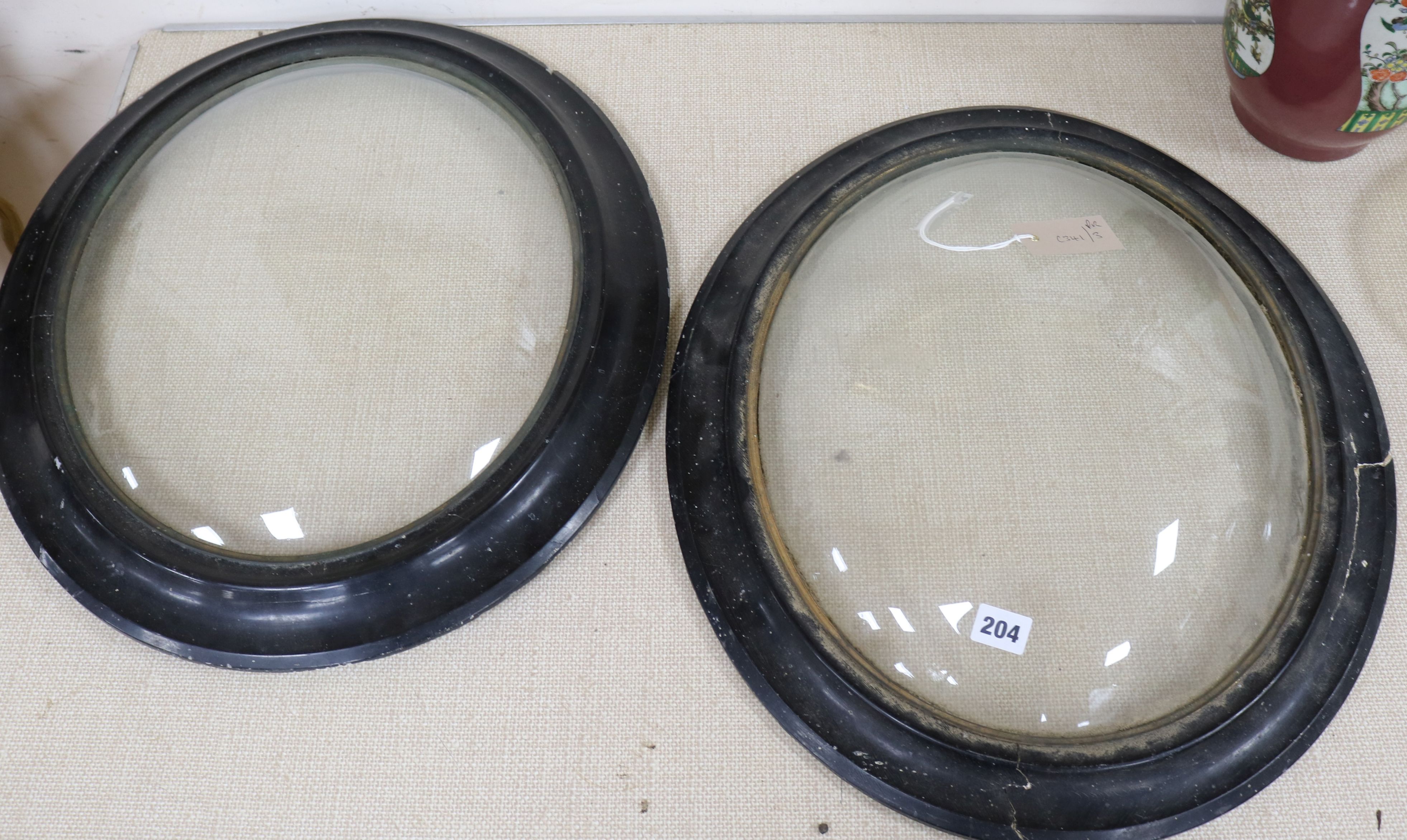 A pair of convex glazed frames length 57cm