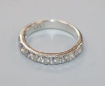 A palladium and nine stone diamond half eternity ring, size M.