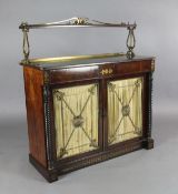 A Regency brass inset rosewood chiffonier, with single raised shelf supported by cast ormolu lyre