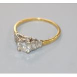 A 1940's 18ct gold, platinum and single stone diamond ring with graduated baguette cut diamond set