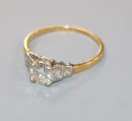 A 1940's 18ct gold, platinum and single stone diamond ring with graduated baguette cut diamond set