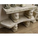 Two reconstituted stone garden benches, on lion supports W.119.5 and 140cm approx