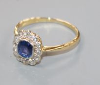 A mid 20th century 18ct gold, sapphire and diamond oval cluster ring, size Q.