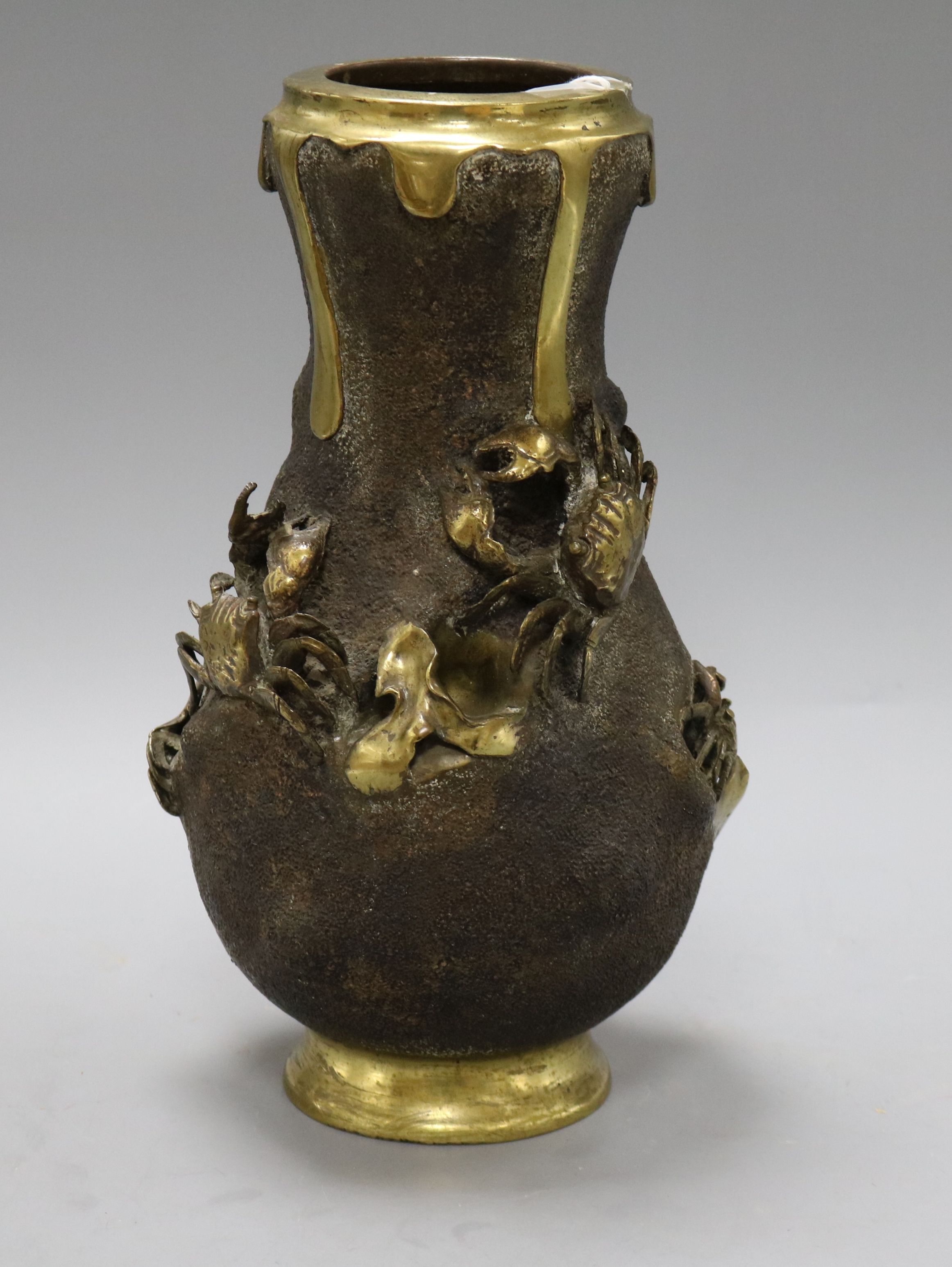 A Japanese Meiji period bronze vase of shaped ovoid form, applied with crabs and weed and having