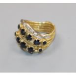 A yellow metal multi shank, sapphire and diamond dress ring, size K.