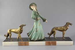 George Maxim (1895-1940). A French Art Deco painted and gilt spelter group of an elegant lady and