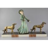 George Maxim (1895-1940). A French Art Deco painted and gilt spelter group of an elegant lady and