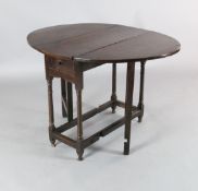 A late 17th century oak gateleg table, with oval top and frieze drawer, W.2ft 9in. H.2ft 4in.