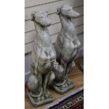 A pair of reconstituted stone model of hounds sejant H.74cm