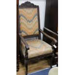 An 18th century French oak elbow chair