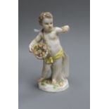 A Meissen figure of a child with flowers height 14cm