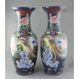 A pair of large Chinese blue ground 'dragon and phoenix' vases, 19th century, painted with dragons