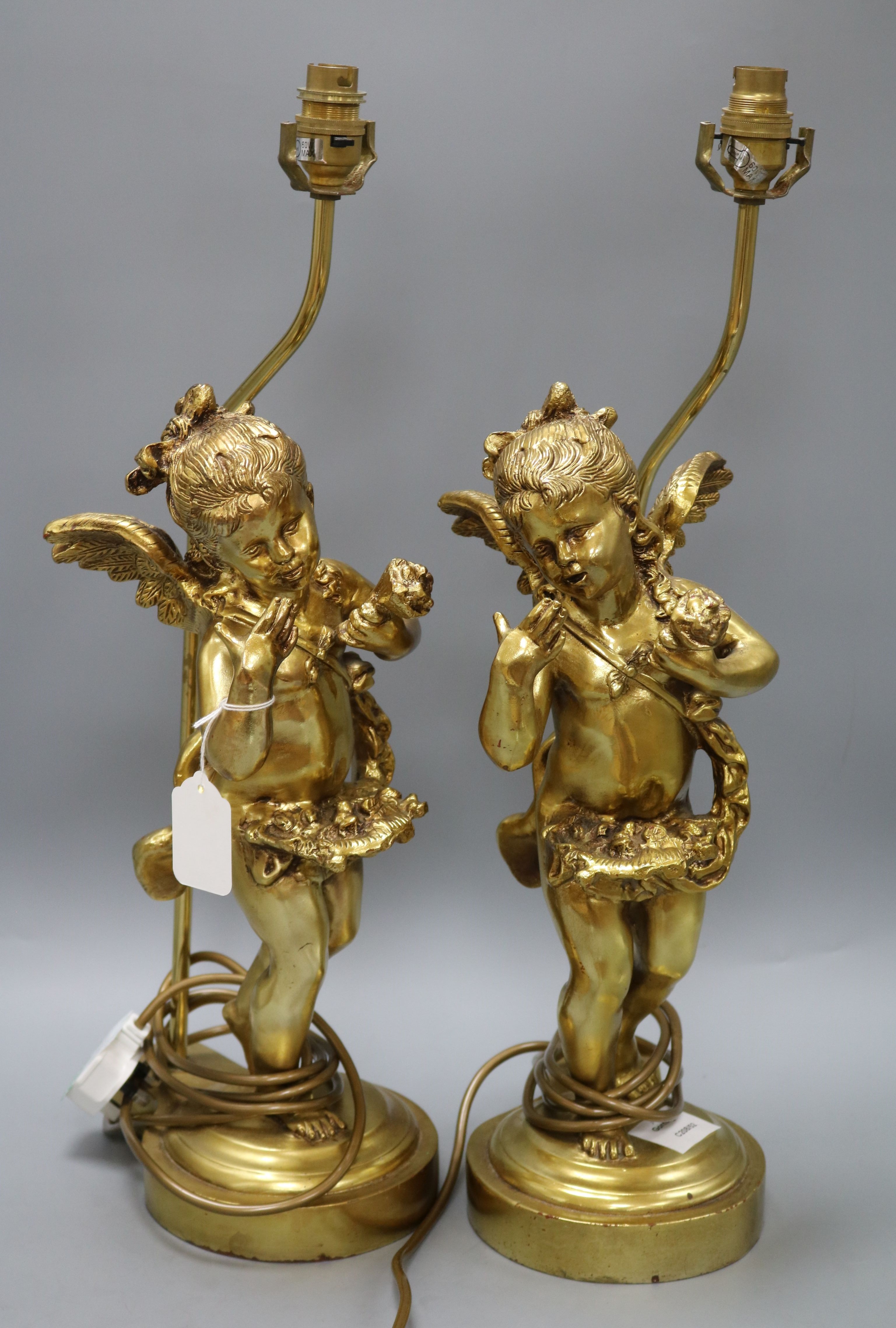 A pair of gilt composition table lamps, the stems formed as amorini height 55cm