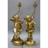 A pair of gilt composition table lamps, the stems formed as amorini height 55cm