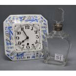 A German porcelain clock and a silver mounted decanter