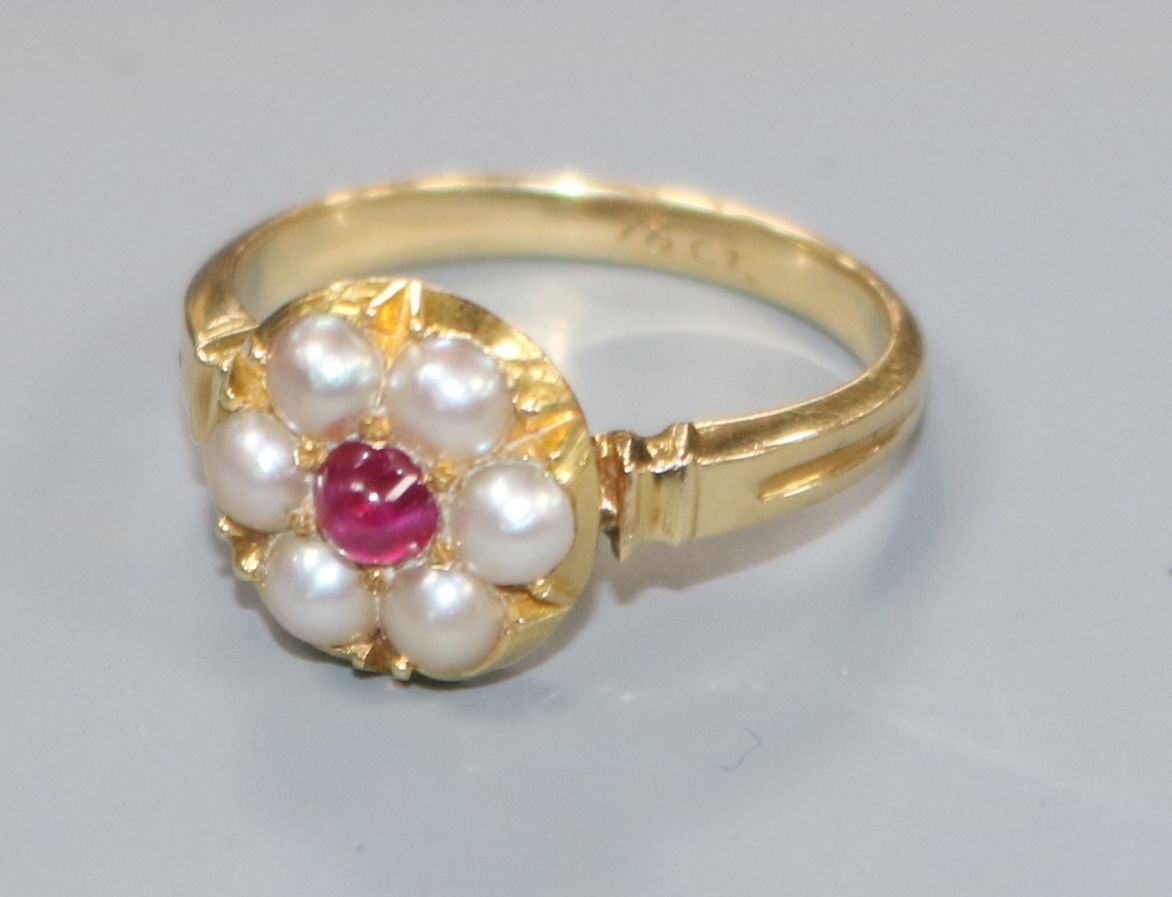 An early 20th century 18ct gold, cabochon ruby and split pearl cluster ring, size M.
