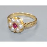 An early 20th century 18ct gold, cabochon ruby and split pearl cluster ring, size M.