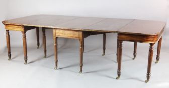 A Regency mahogany dining table, comprising central drop leaf and two D shaped ends, on turned