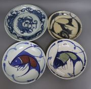 Three Chinese blue and white fish dishes and a similar dragon dish